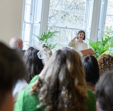 a woman in a white dress standing in front of a crowd of people