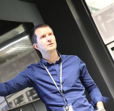 Image of Nick Power presenting an innovation workshop and motioning to the TV screen