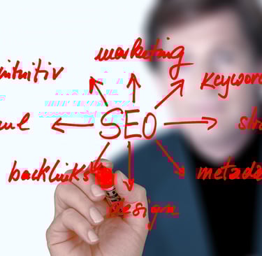 A person sketching an SEO strategy diagram with keywords like backlinks, marketing, and metadata on glass.
