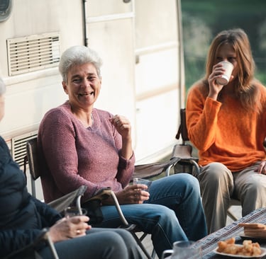 Family drinking coffee and eating breakfast outside while enjoying the great outdoors at an RV Park