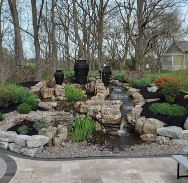 Custom backyard stone water feature and landscaping design by Mr. Grass, LLC in Canandaigua, NY