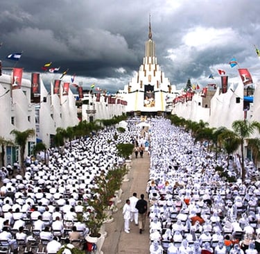 Crowd of worshippers in white at La Luz del Mundo temple in Guadalajara under cloudy skies.