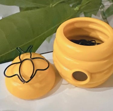 Open bee paper clip holder showing bee-shaped paper clips inside, with magnetic lid for easy access