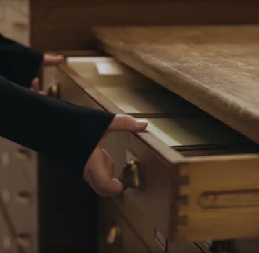 Hands opening a plan chest in an archive store
