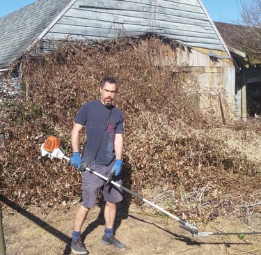picture of a man holding gas hedge trimmers
