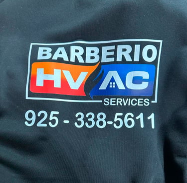 Barberio HVAC Services logo on black fabric with phone number for heating and cooling repair.