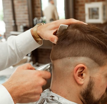 Man styling a fade haircut at home with pomade — West Springs Landing Barbershop Calgary