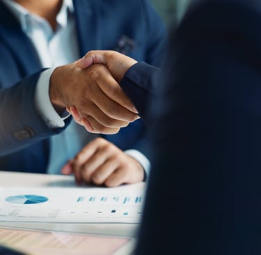 Two businesspeople shake hands after reaching an agreement