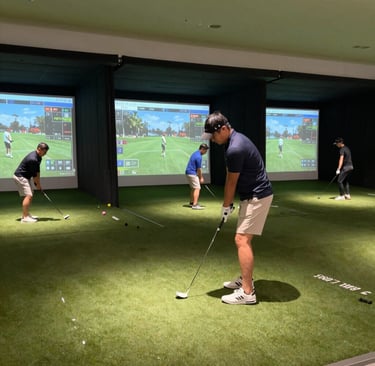 A vibrant golf simulator room with players enjoying a realistic game experience.