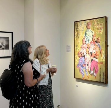 Visitors looking at my painting 'Playthings' at an AA2A Exhibition in Chester. 