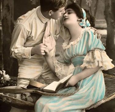 Vintage postcard of a romantic Edwardian couple posing with a tennis racket in a hammock.