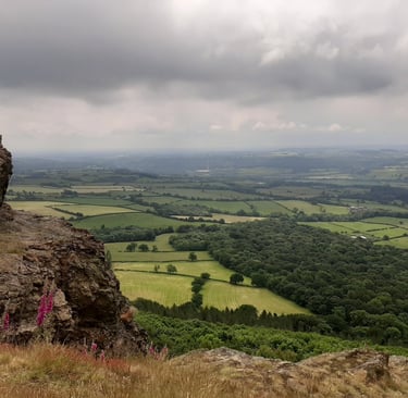 Panoramic view of green English countryside valleys and rolling hills from The Wrekin.