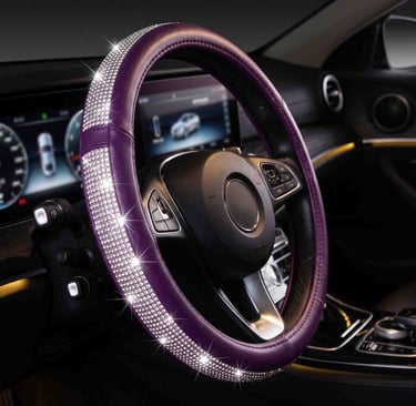 Purple leather steering wheel cover with sparkling rhinestones for car interior decoration.
