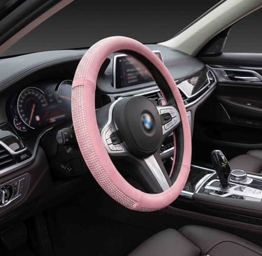 Sparkling pink rhinestone steering wheel cover installed in a luxury car interior with leather seats.