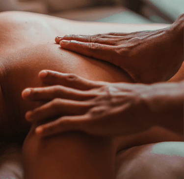 Close-up of a professional therapist performing a deep tissue shoulder massage for muscle relief.