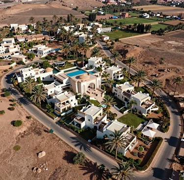 View of a modern boundary marker with the Oréa Tangier logo against a backdrop of open land.