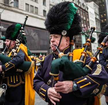 NYPD pipe and drum band members playing bagpipes during a St. Patrick's Day parade in New York City.
