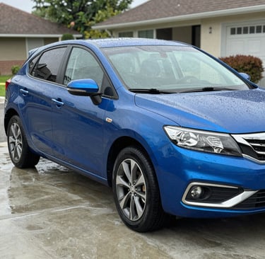Close-up of a technician carefully cleaning a car dashboard with detailed precision.