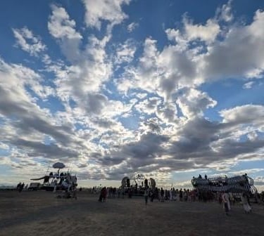 a group of people standing around a large group of people