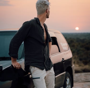 a man standing next to a car with a black shirt