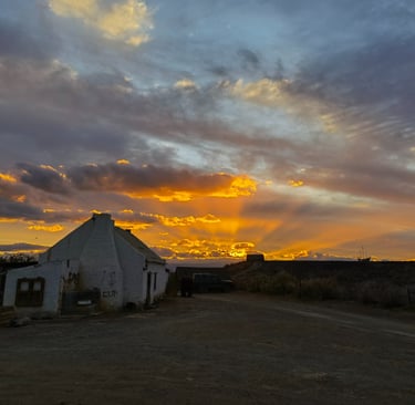 a house with a sunset in the background