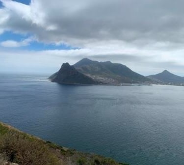 a person sitting on a bench in the middle of a mountain
