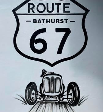 a street sign with a drawing of a car on Route 67, Bathurst, Eastern Cape