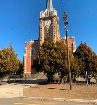 a church steeple with a clock tower in the background