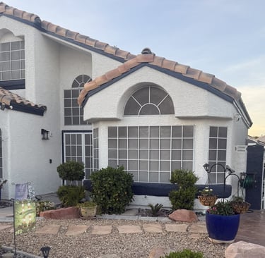 Newly painted house with numerous old colonial style solar screens
