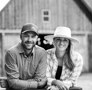 about - christina dave in front of barn b&w