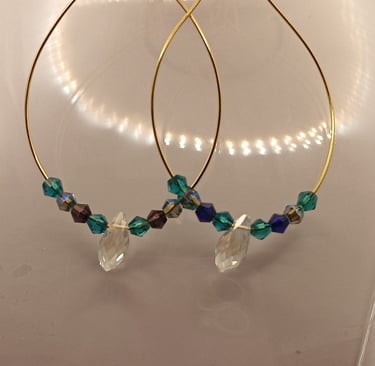 Elegant gold hoop earrings featuring iridescent blue and green beads with clear crystal pendants.