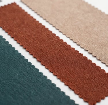 Detailed shot of fabric edges highlighting the gsm and weave quality in a sleek folder.