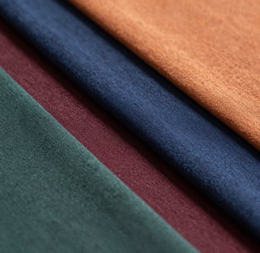 Fabric folder resting on a dark surface with subtle gold accents reflecting luxury and quality.