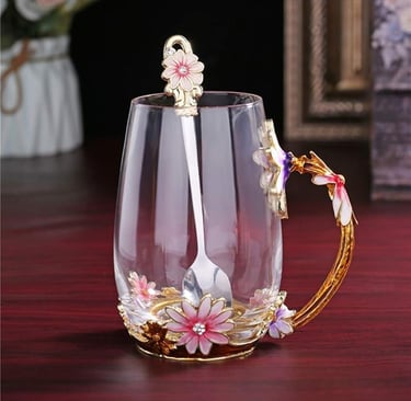 Handmade glass tea cup with enamel butterfly and floral handle, elegant gift idea.