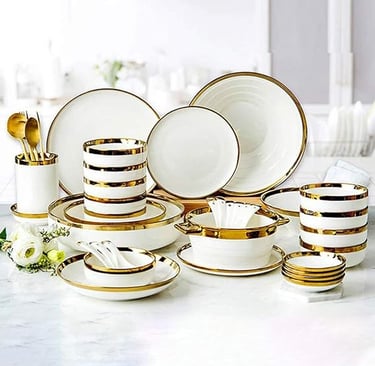 White porcelain dinner set with gold stripe detailing, high-end luxury tableware collection.