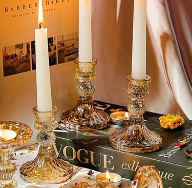 Crystal glass candlesticks set displayed on a gold tray, elegant table décor.