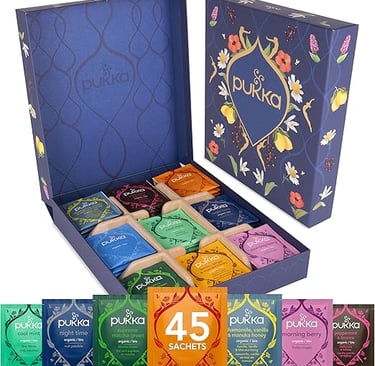Pukka herbal tea gift box with mixed flavours in colourful sachets, premium wellness gift.