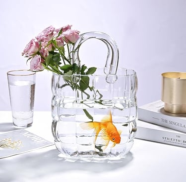 Clear glass handbag-style vase with fresh flowers, modern decorative table vase.