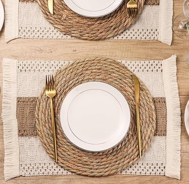 Set of round woven boho placemats in natural straw tones, rustic table styling décor.