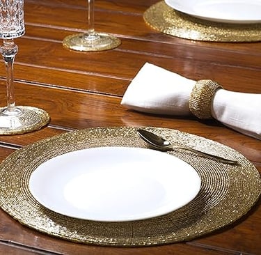 Set of beaded hand-crafted charger mats in warm neutral tones, luxury table setting accents.