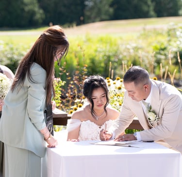 man and woman signing document 