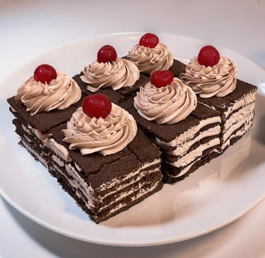 Seis rebanadas de pastel de crema de chocolate en capas cubierto con glaseado batido y cerezas rojas