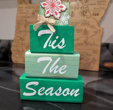 Rustic green wooden block stack Christmas decoration with Tis the Season script and snowflake topper.