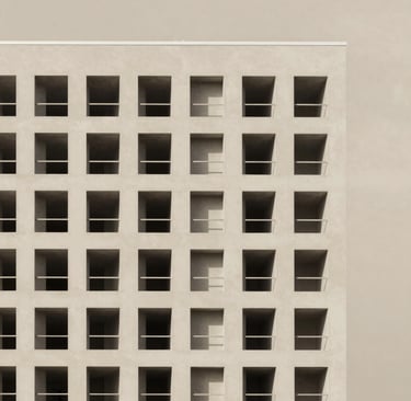 Exterior shot of a modern building showcasing geometric shapes in white and beige against a clear sky.