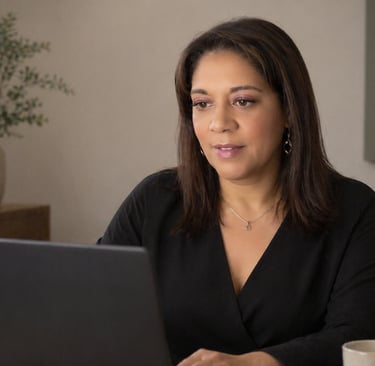 Professional woman working on a laptop in a modern home office setting.