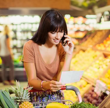 a woman in a grocery store with a shopping carton