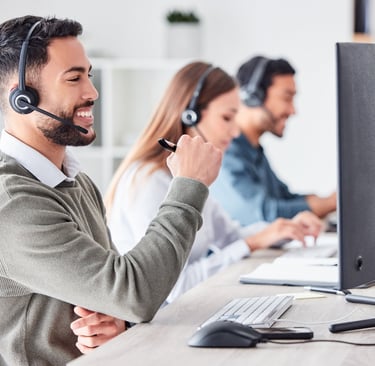 An image of helpdesk agents supporting customers over a VOIP system