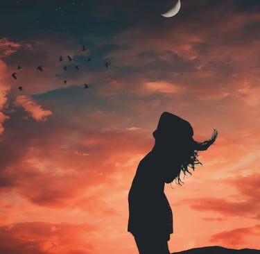 Woman standing before a dramatic red sky