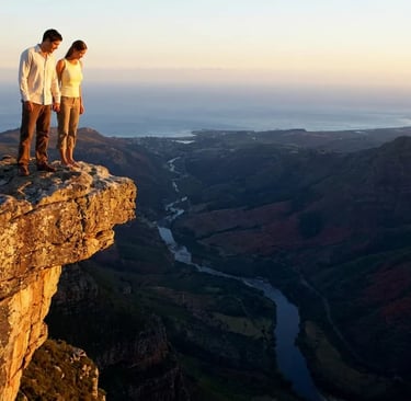 Christian dating couple standing on the edge of a cliff, about to fall in love