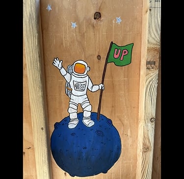 Shipping crate for Talbotics sculpture with image of astronaut drawn on it.
